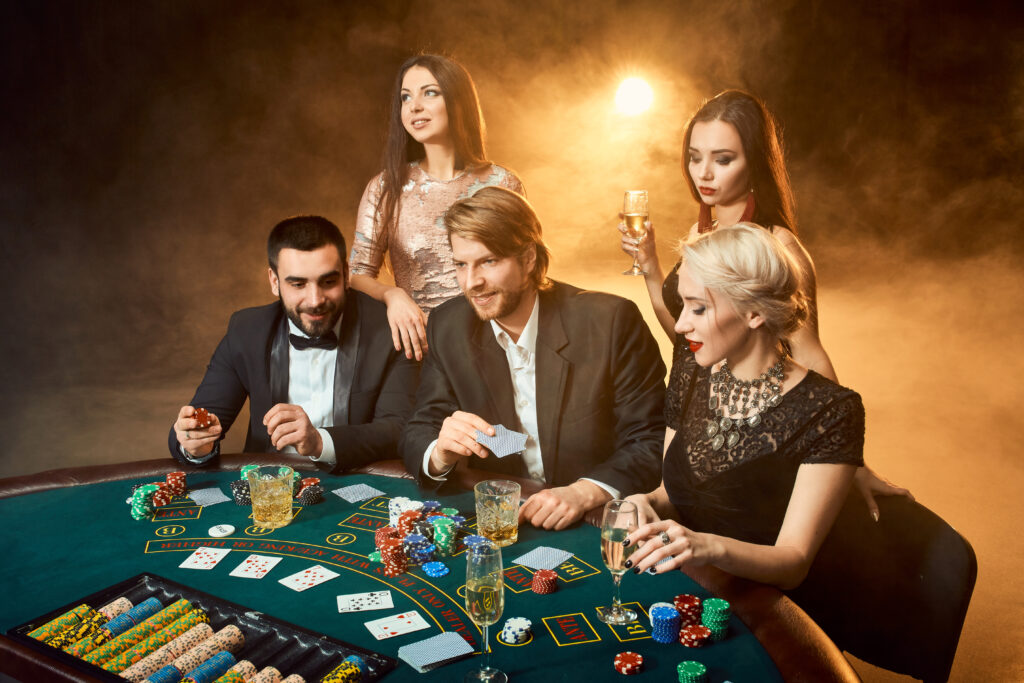 Poker players sitting around a table at a casino.